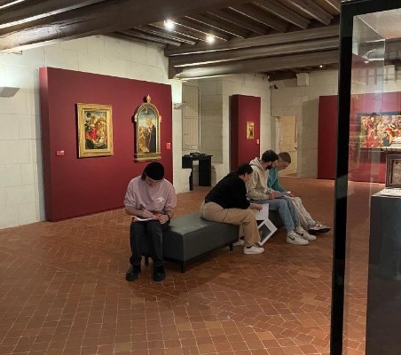 4 étudiants assis sur un banc dans le musée